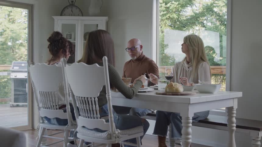 A family discuss things while having a meal together