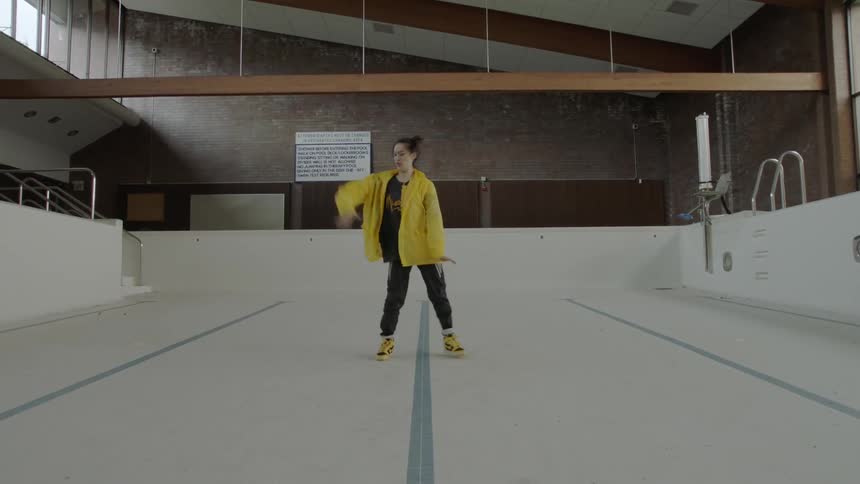 Woman dancing in an empty pool