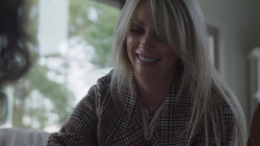 A woman is smiling while she talks
