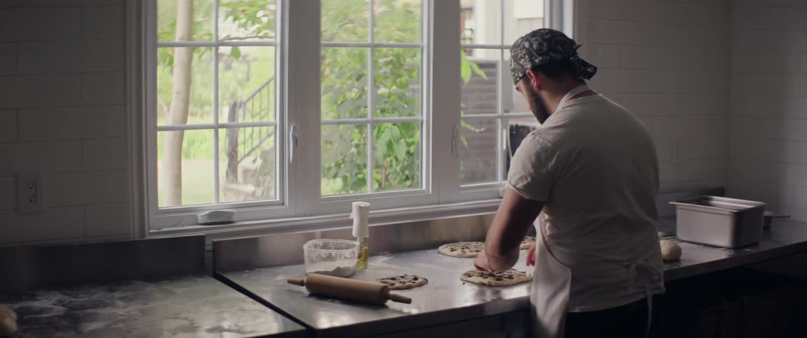 A man preps food in an industrial kitchen