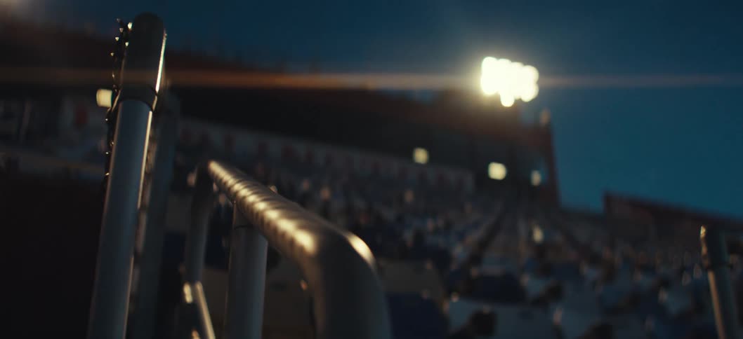 Empty stadium stands with floodlights on