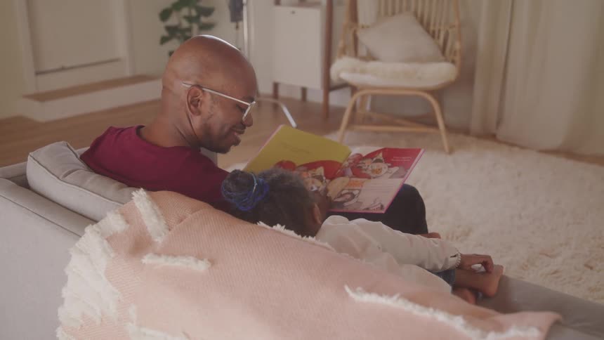 A footage of a man studying with a kid