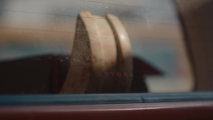 A wooden item is in back of the car