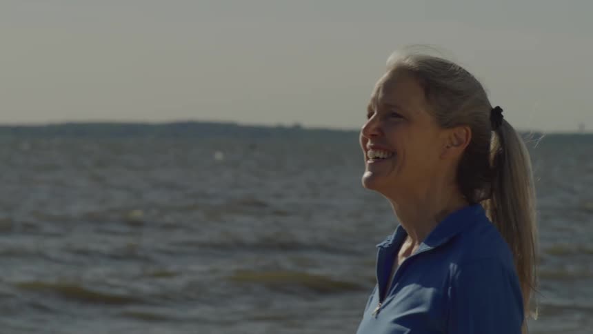 Smiling woman by the sea