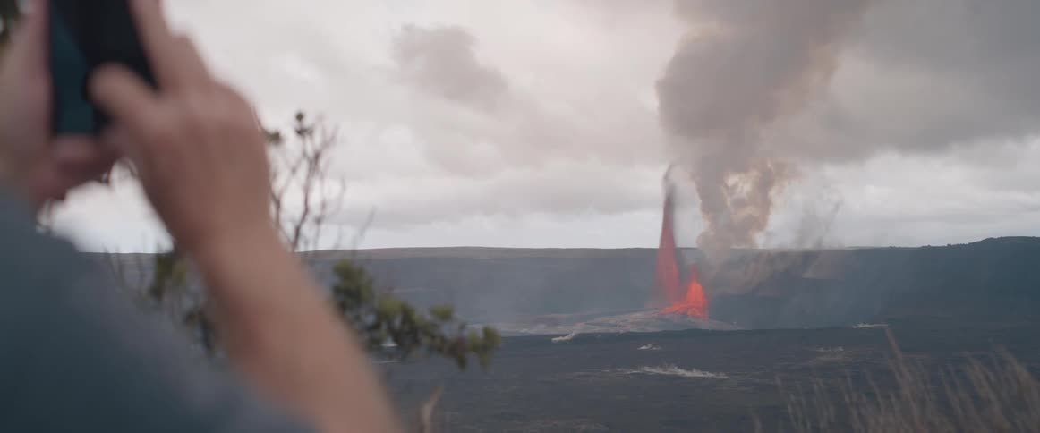 A man records an active volcano with his phone