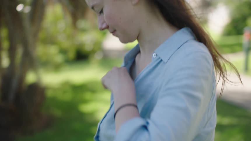 Woman putting a device on her waist and checking the microphone