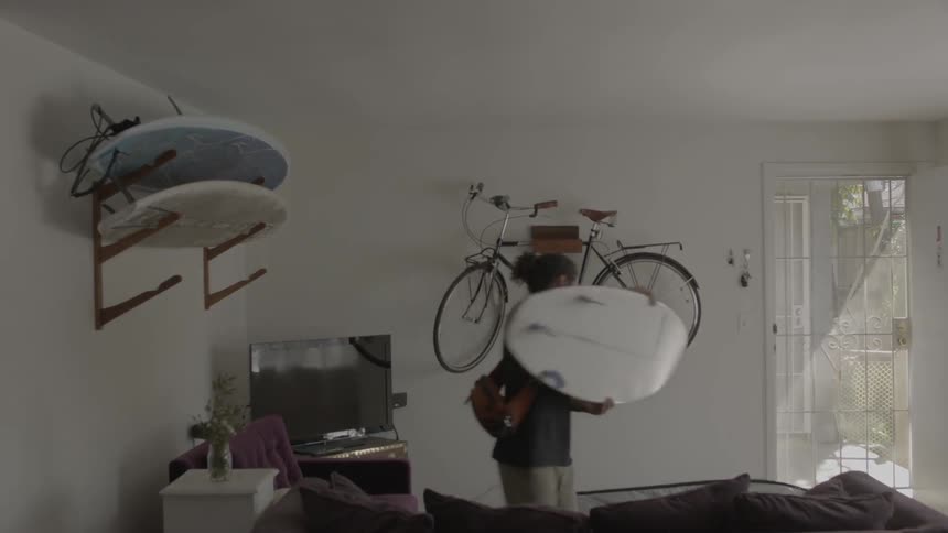 A person grabbing a surfboard