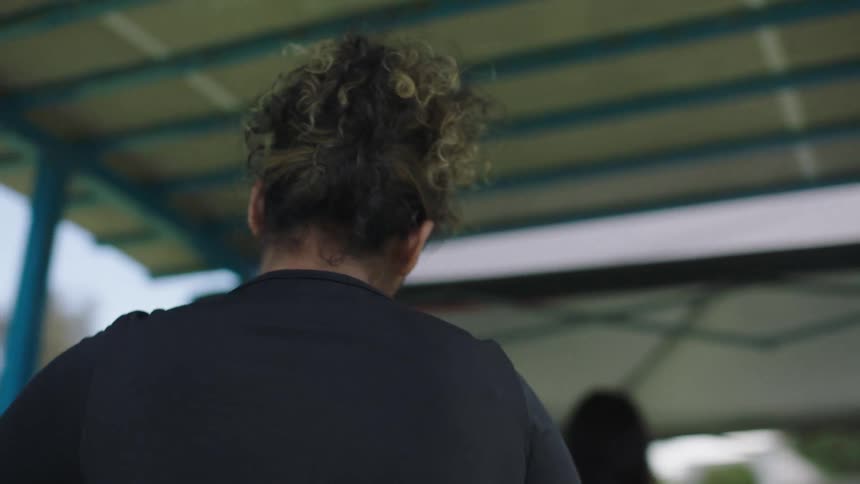 Woman spraying another womans hair with spray