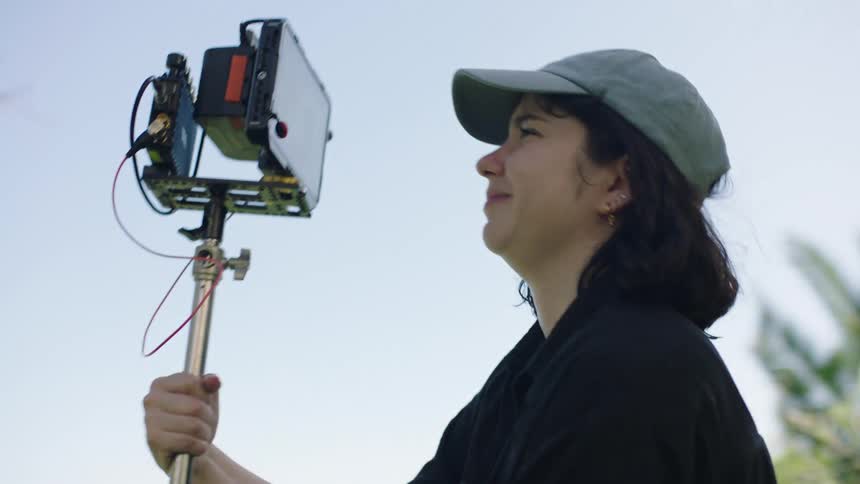 Female filmmaker using a professional camera in an outdoor setting