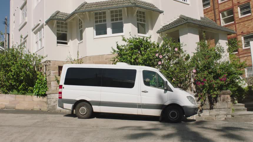 White van parking next to a residential area