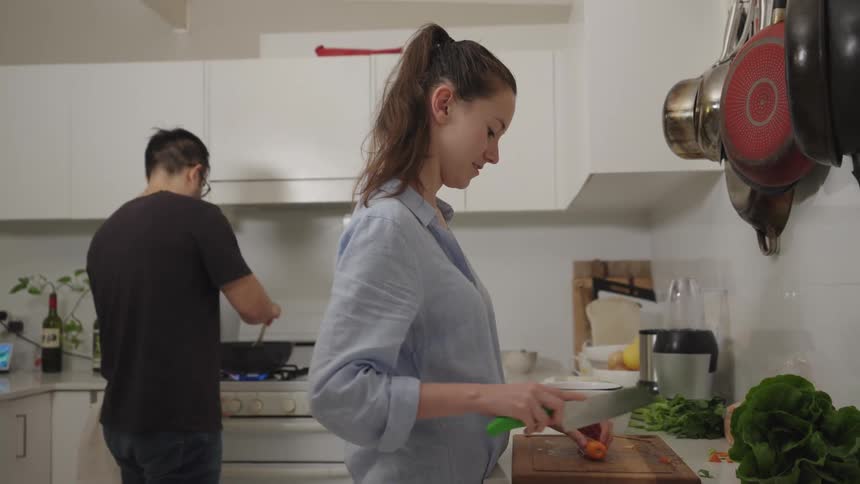 Woman and a man cooking together in the kitchen
