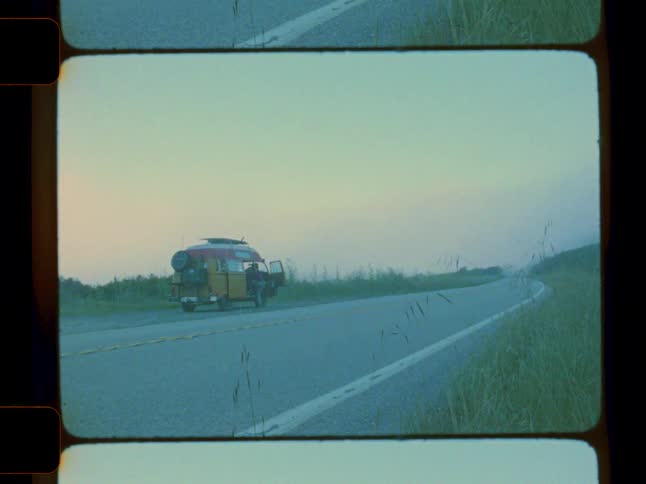 A van is parked on the shoulder of the road