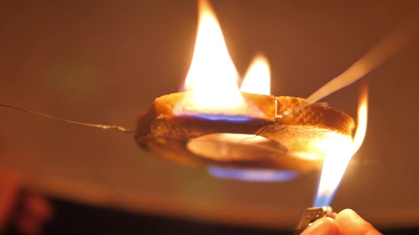 A lighter ignites a floating lantern