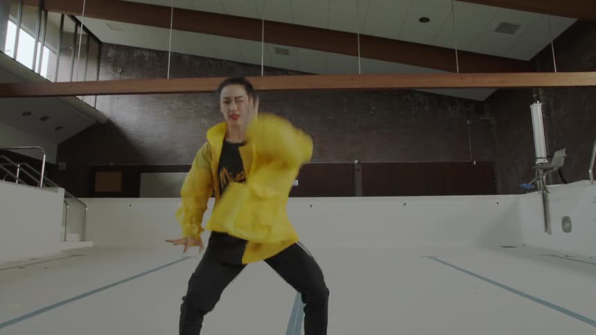 Woman dancing in an empty pool