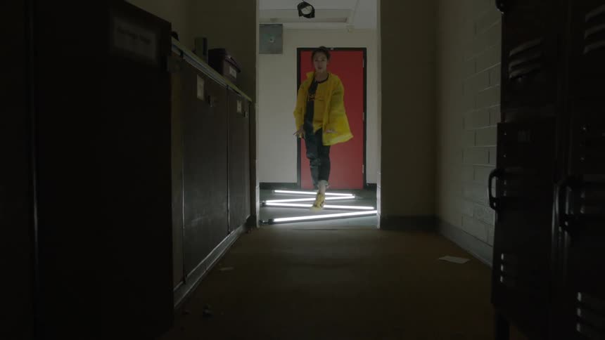 Woman dances in a hallway