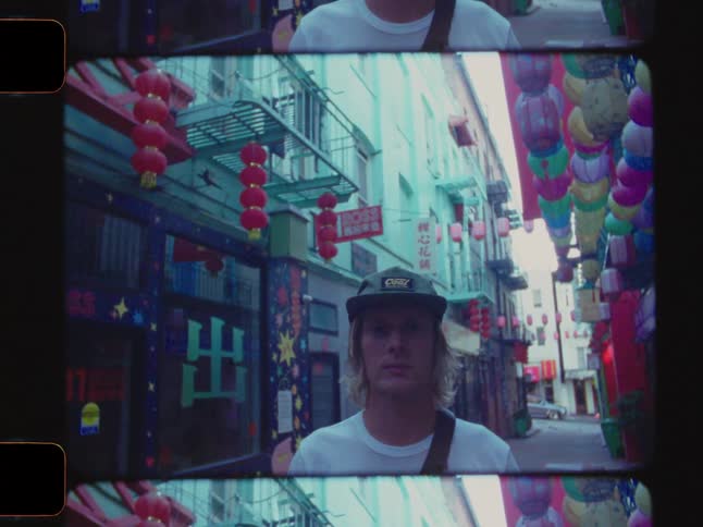 Portrait of a man wearing a cap in a hallway in an asian neighborhood