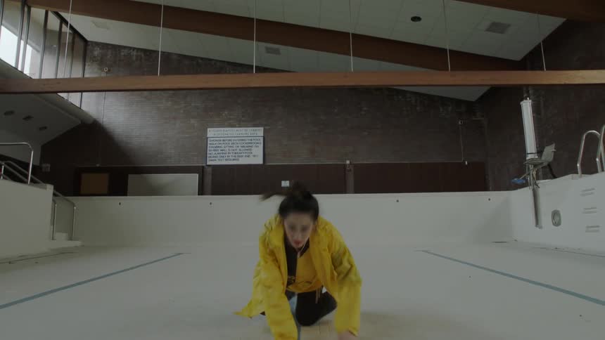 Woman dancing in an empty pool