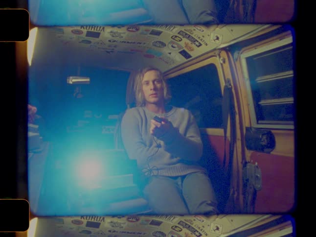 A man is using a projector in his van