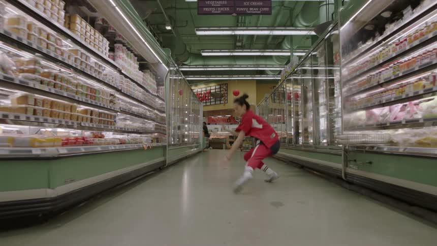 Woman dances in the aisle of a grocery store