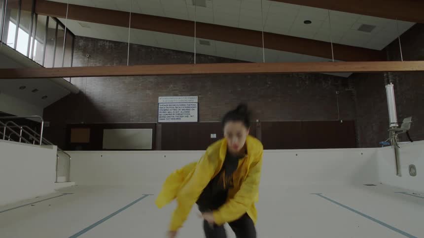 Woman dancing in an empty pool