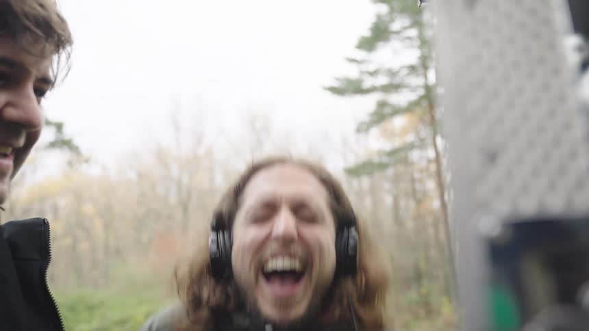 2 males laughing while working