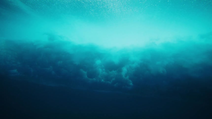 The wave crashes and causes clouds to go underwater
