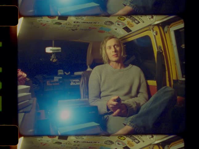 Man inside a van and handling a projector control