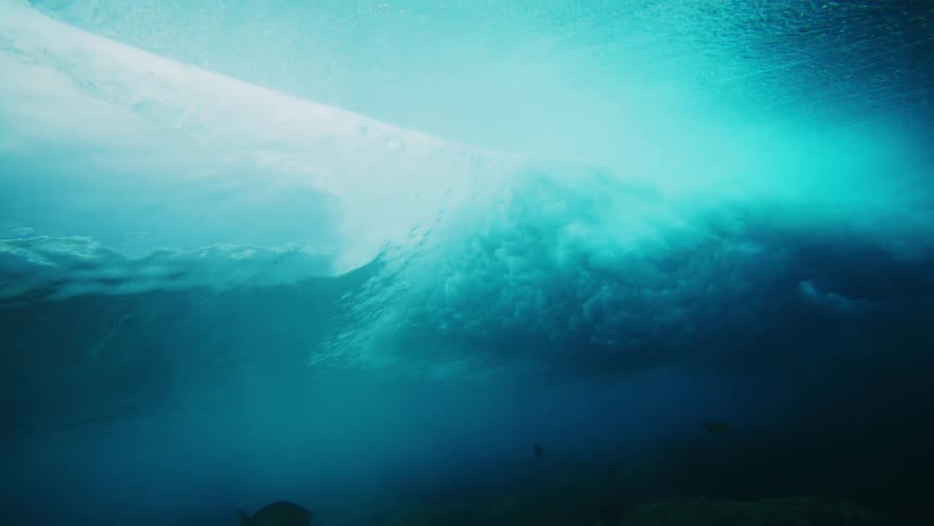 A wave rolls and moves underwater