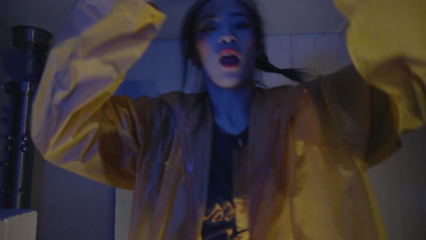 Woman dances in a dark office at night