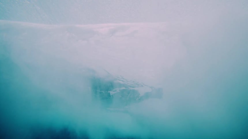Below view of a tubular wave breaking in the ocean