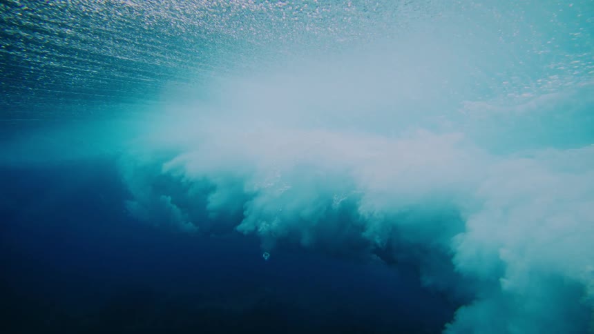 The wave spins and turns as it crashes