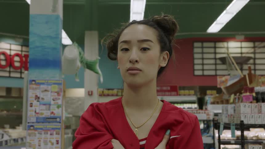 Woman stands in the middle of a grocery store