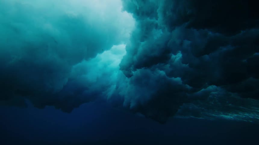 Underwater view of wave crashing above coral reefs