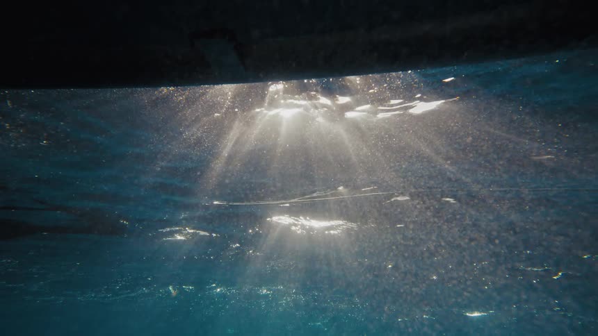 Submerged view in the ocean with reflections of sun rays