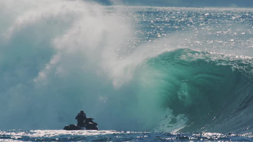 Sea wave with people surfing in it