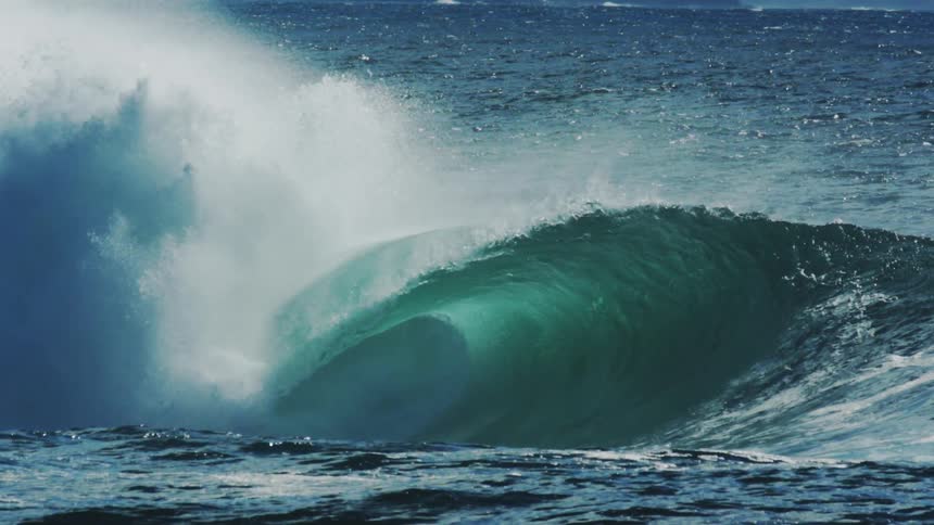 Turquoise blue tubular wave breaking in the ocean