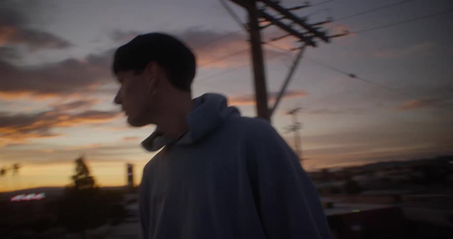 A teenager turns around while walking