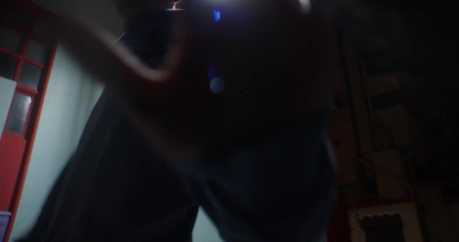 A man reaches his hand out as he walks and spins