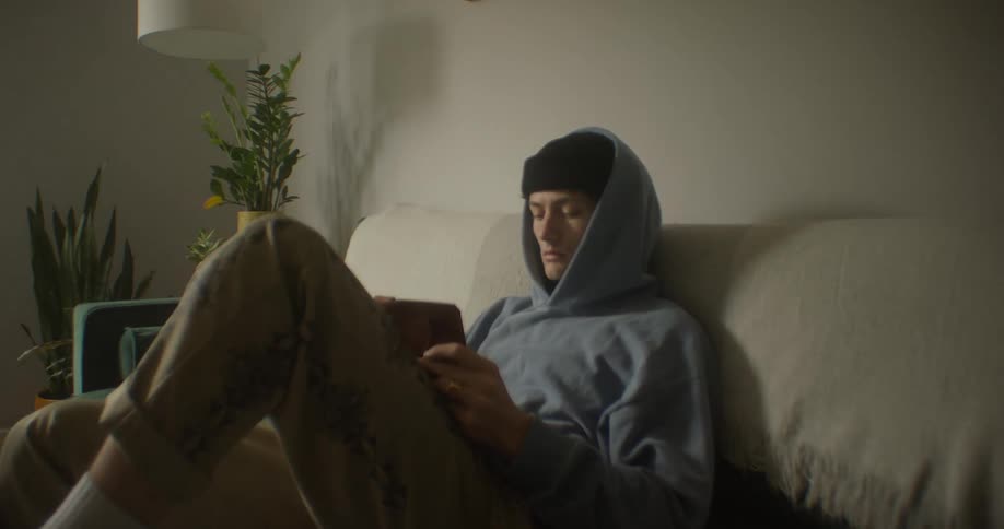 Man sitting writing in a notepad