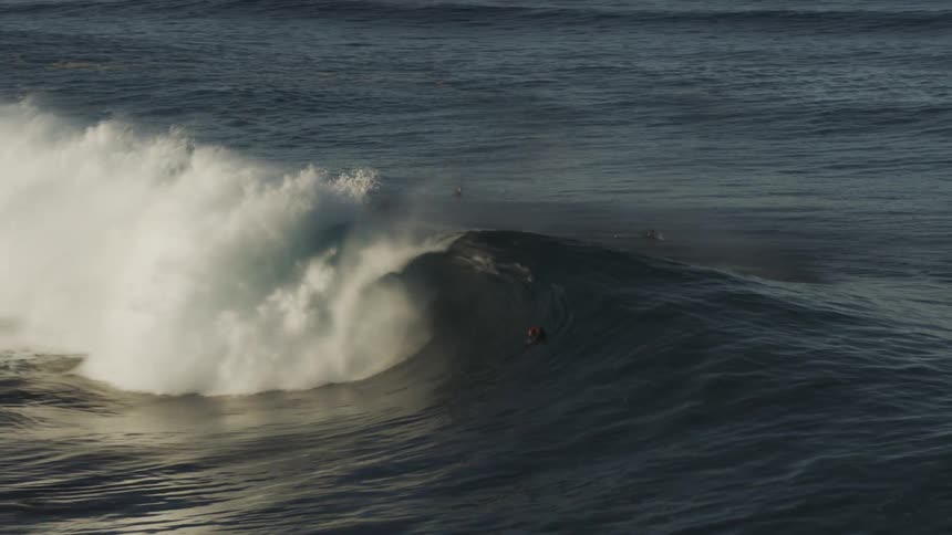 Wave of a sea with people in it