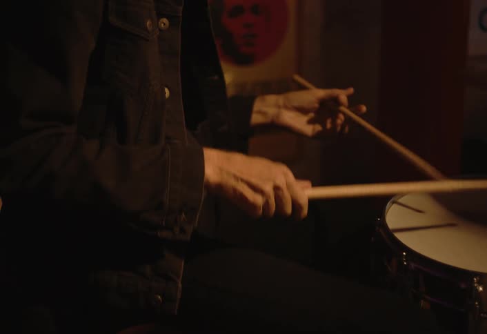 A footage of a person drumming