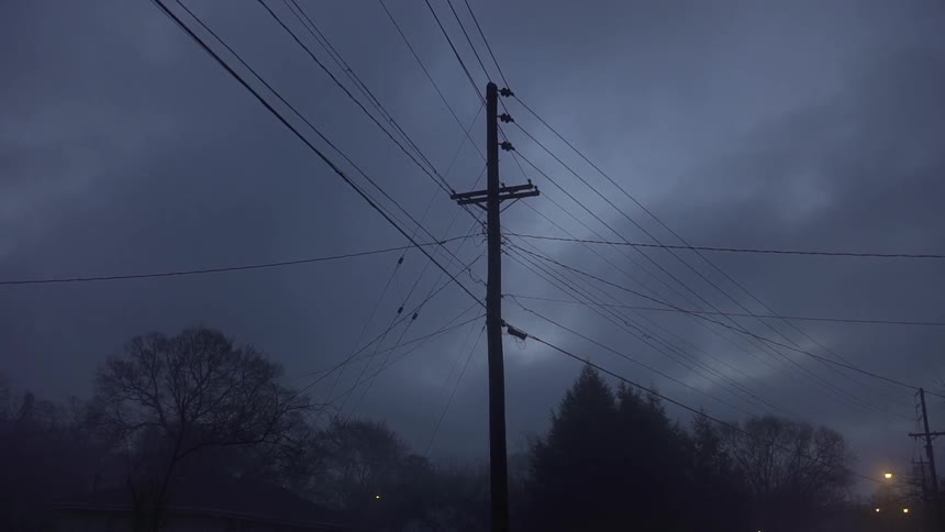 Telephone poles on a cloudy night