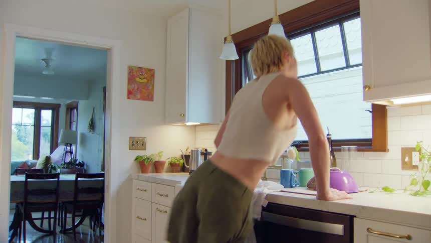 Woman in the kitchen dancing