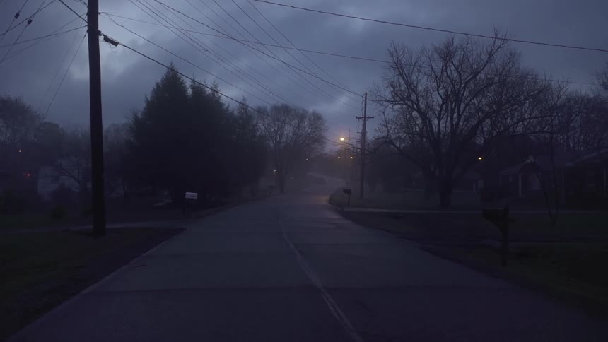 A foggy abandoned street at night