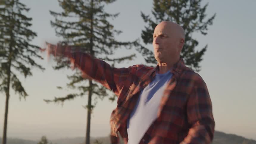 A man is playing catch on a sunny day