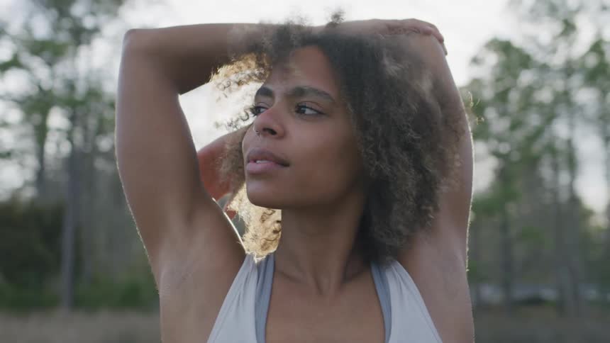 A woman is stretching outside