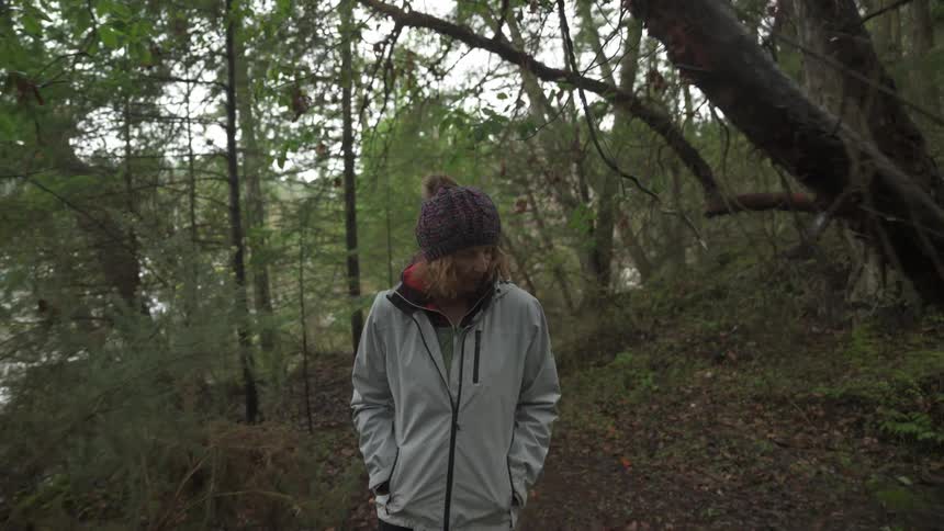 A woman is hiking in the forest