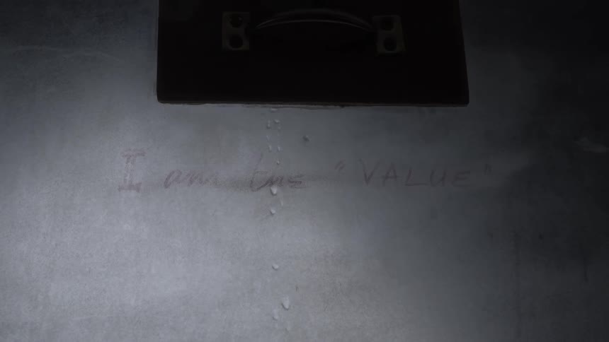 A metal surface covered with water droplets with a rectangular opening accompanied by partially visible text that says i am a value