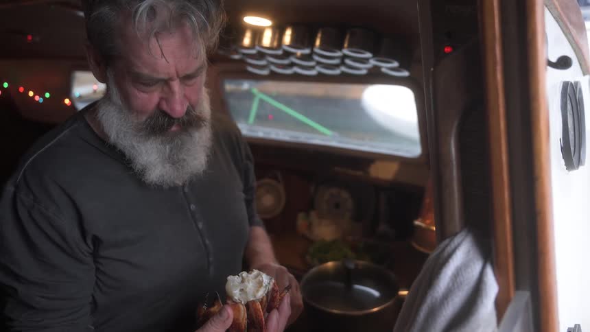 Bearded man cooking crab pieces