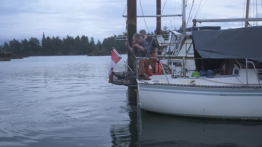 Two people in a boat pulling a fishing rope